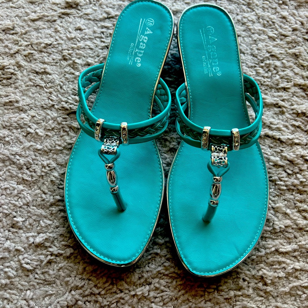 Size 10 aqua blue with silver accents sandals with a 1 in wedge heal.